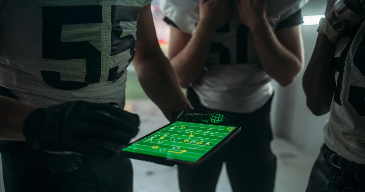 A coach with a tablet at practice